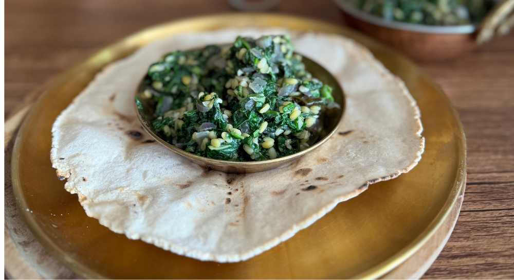 Image of green leafy veg stir-fry served with flatbread, a vegan dish and gluten free food meals suitable for a gluten dairy free recipe.